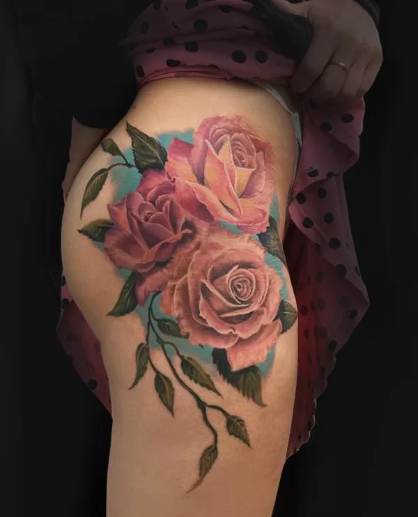 Color tattoo on a womans hip roses ibiza